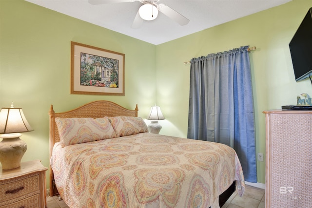 bedroom with ceiling fan and light tile patterned floors