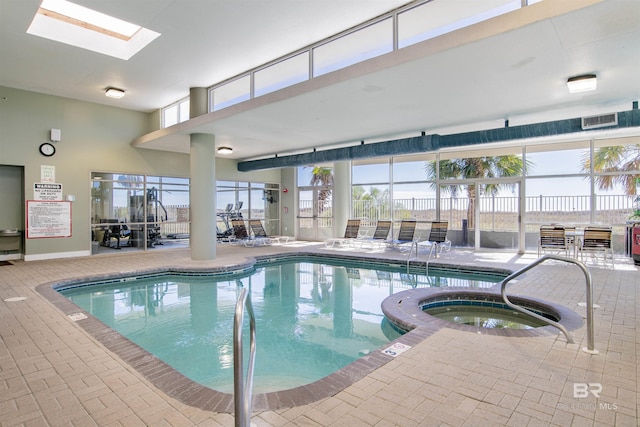 view of swimming pool with a skylight