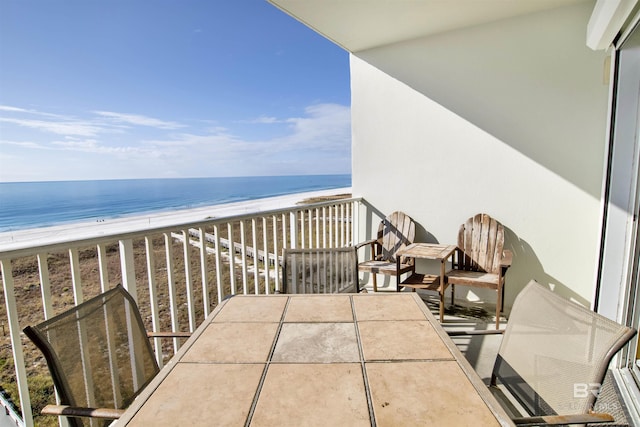 balcony featuring a water view and a view of the beach