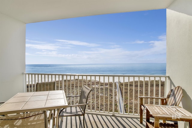 balcony with a water view and a beach view