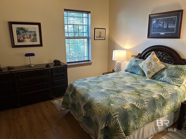 bedroom with dark hardwood / wood-style floors