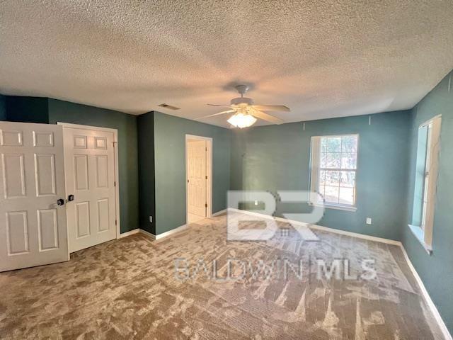 unfurnished room with ceiling fan and carpet flooring