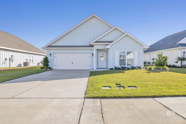 view of front of home featuring a garage, a front lawn, and central air condition unit