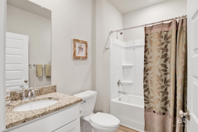 full bathroom with hardwood / wood-style floors, vanity, toilet, and shower / bath combo with shower curtain