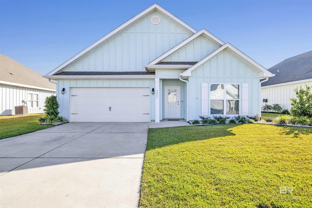 view of front facade featuring a front yard, a garage, and central air condition unit