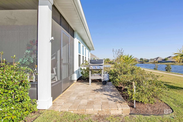 view of patio / terrace with area for grilling and a water view