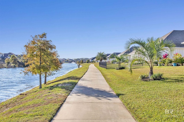 view of community featuring a lawn and a water view