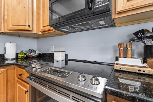 kitchen with black microwave, dark stone countertops, brown cabinets, and stainless steel range with electric cooktop