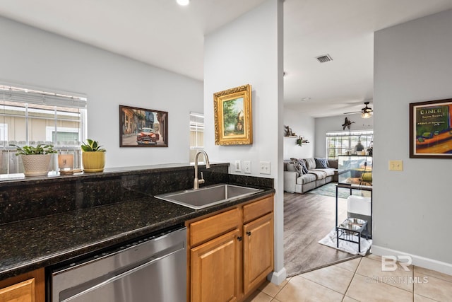 kitchen with light tile patterned floors, visible vents, open floor plan, a sink, and dishwasher