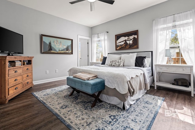 bedroom featuring multiple windows, baseboards, and dark wood-style flooring