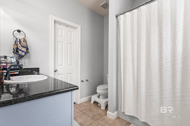 bathroom with visible vents, toilet, a sink, tile patterned flooring, and baseboards