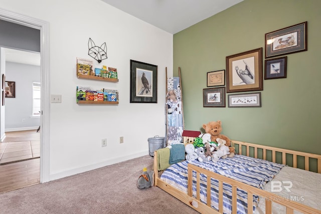 bedroom with carpet flooring and baseboards