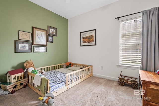 bedroom featuring baseboards, ceiling fan, multiple windows, and light colored carpet