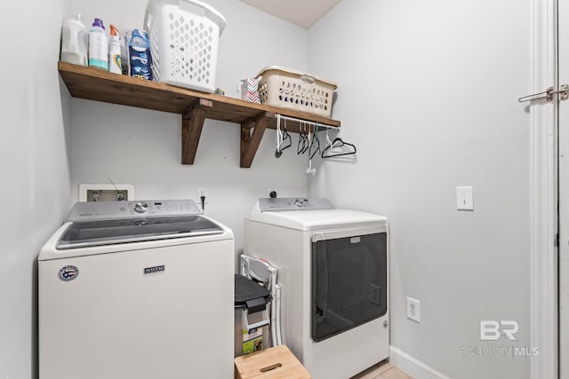 laundry area with laundry area, baseboards, and separate washer and dryer