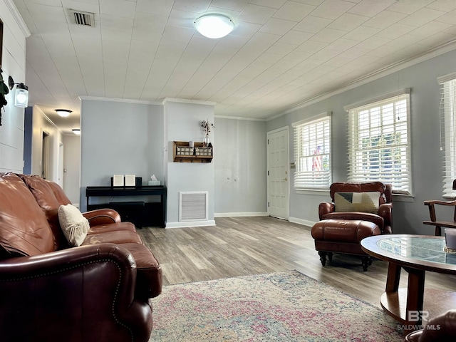 living room with light hardwood / wood-style floors and ornamental molding