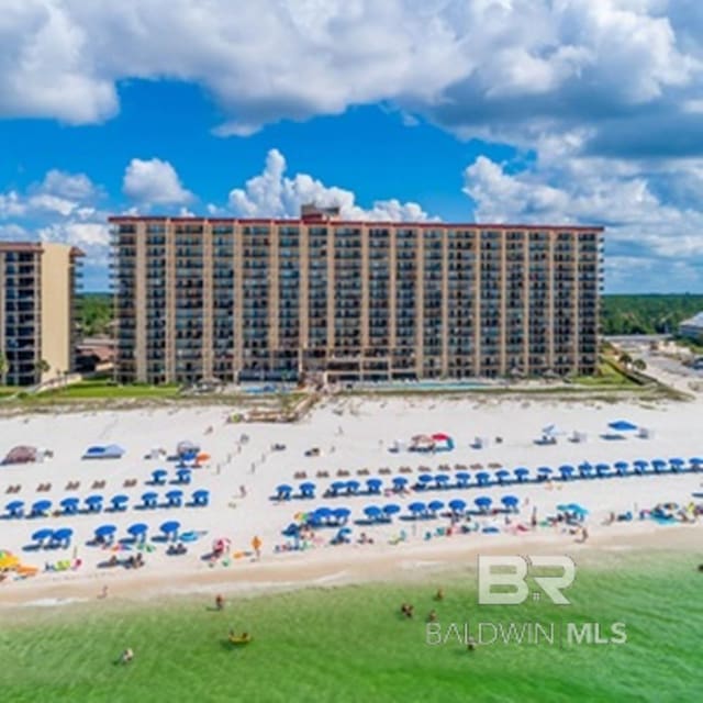 birds eye view of property featuring a water view and a view of the beach