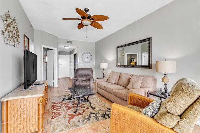 living area with light tile patterned floors, visible vents, and a ceiling fan