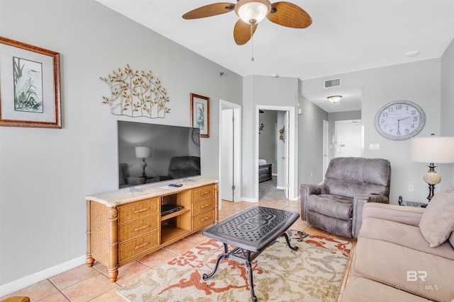 living area with light tile patterned flooring, baseboards, a ceiling fan, and visible vents