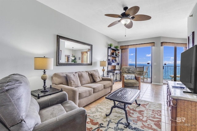 living room featuring light tile patterned floors, baseboards, and ceiling fan