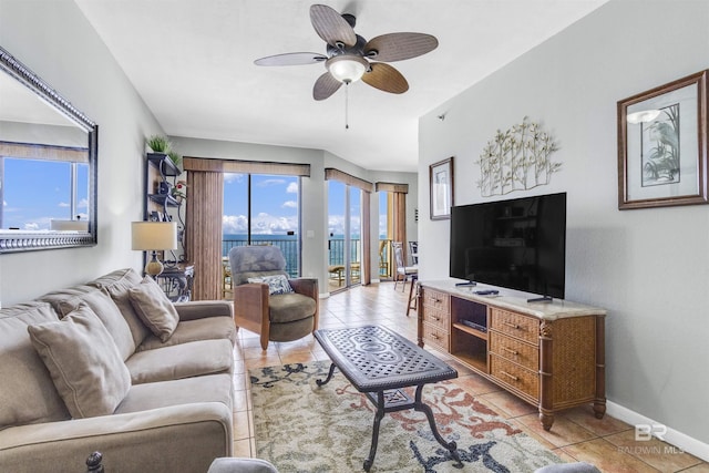 living room with baseboards, ceiling fan, and light tile patterned flooring