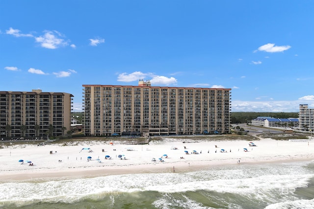 view of property with a view of the beach and a water view