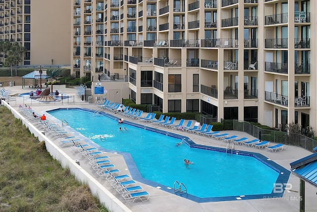pool featuring a patio area and fence