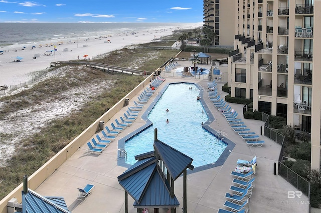 community pool featuring a beach view and a water view