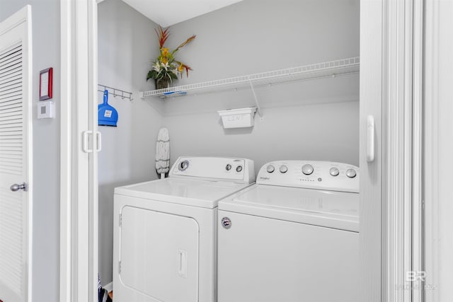 washroom with laundry area and washer and dryer