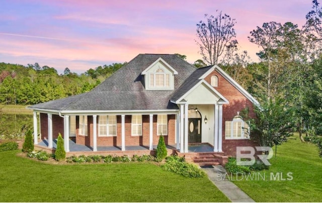 17243 N Lake Dr Unit C, Bay Minette, AL 36507 - view of front of property featuring brick siding, a front lawn, and a porch