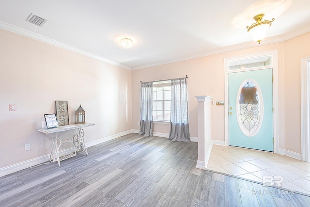 foyer with ornamental molding and light wood-type flooring