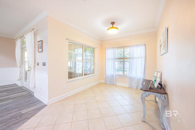 entryway with crown molding and light tile patterned floors