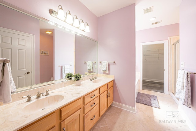 bathroom with tile patterned flooring, vanity, a shower with shower door, and toilet