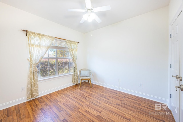 spare room featuring wood-type flooring and ceiling fan