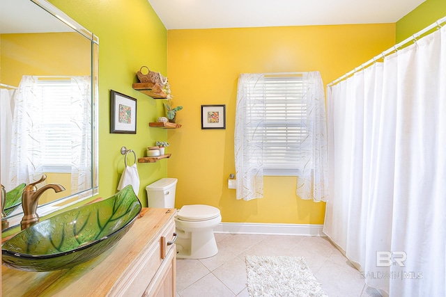 bathroom featuring tile patterned flooring, vanity, and toilet