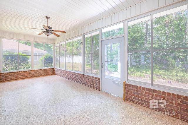 unfurnished sunroom with ceiling fan