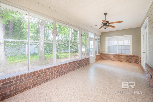 unfurnished sunroom featuring ceiling fan