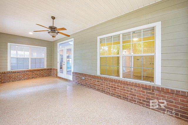 unfurnished sunroom featuring wooden ceiling, french doors, and ceiling fan