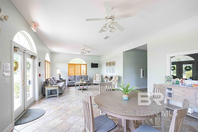 dining room featuring beverage cooler, ceiling fan, and french doors