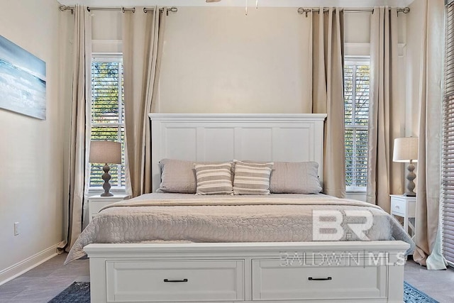 bedroom featuring hardwood / wood-style floors and multiple windows