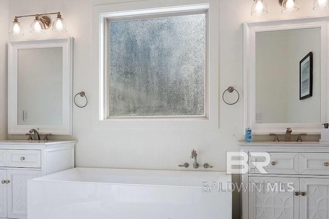 bathroom with vanity and a tub