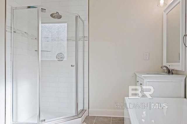 bathroom featuring tile patterned floors, vanity, and an enclosed shower