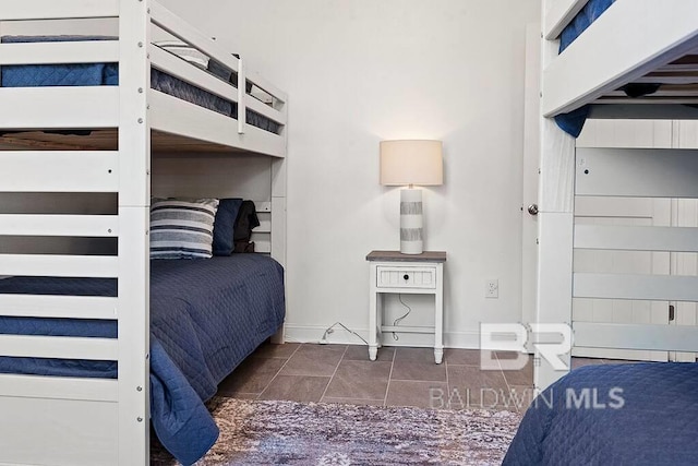 unfurnished bedroom featuring dark tile patterned flooring