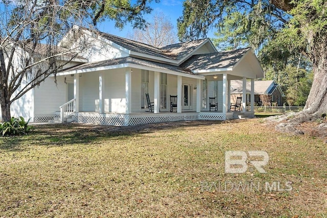 view of front of house with covered porch and a front yard