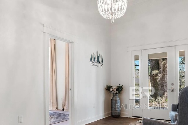 doorway to outside with a chandelier, dark hardwood / wood-style flooring, and a healthy amount of sunlight