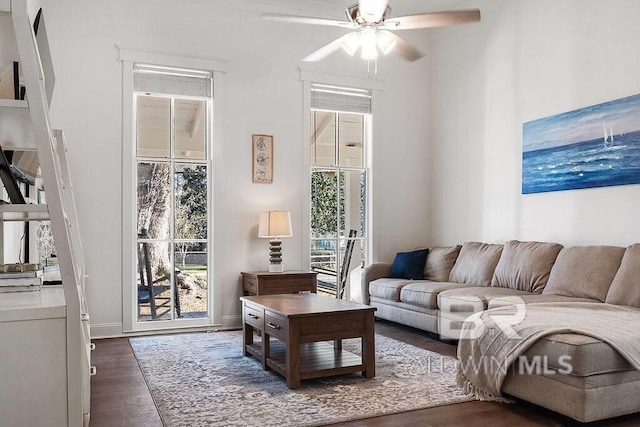 living room featuring dark hardwood / wood-style flooring and ceiling fan