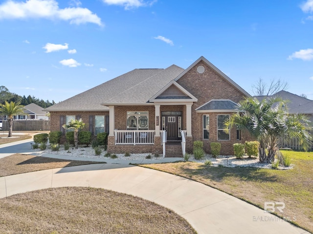 view of front of property with a porch and a front lawn