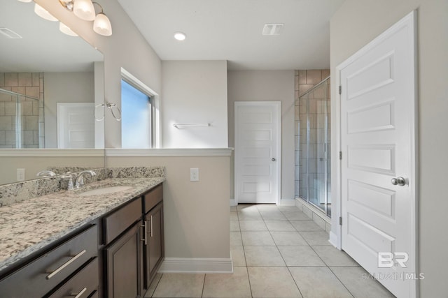 bathroom featuring vanity, tile patterned floors, and walk in shower