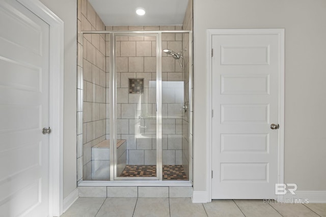 bathroom with tile patterned floors and walk in shower