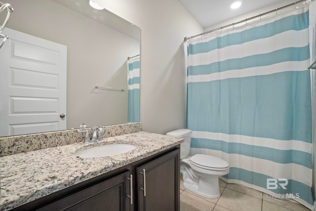 bathroom featuring tile patterned floors, a shower with curtain, vanity, and toilet