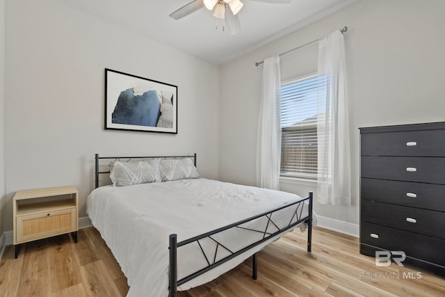 bedroom featuring hardwood / wood-style floors and ceiling fan